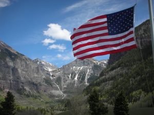 American flag with Telluride in the background