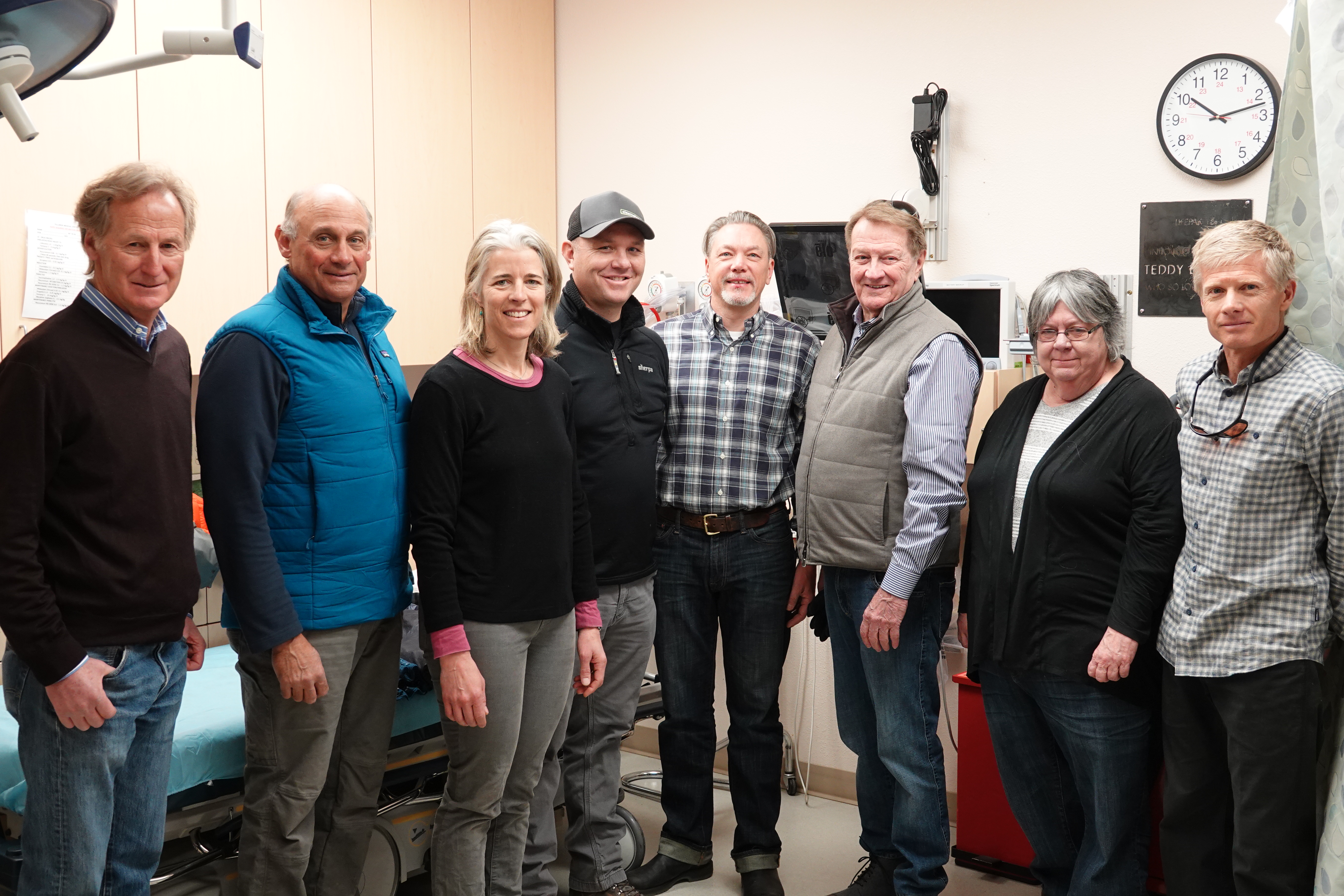 Photo of Telluride Foundation Broadband Staff Six man and two women are standing in a room together.