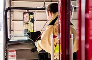 Firefighter looking in a mirror