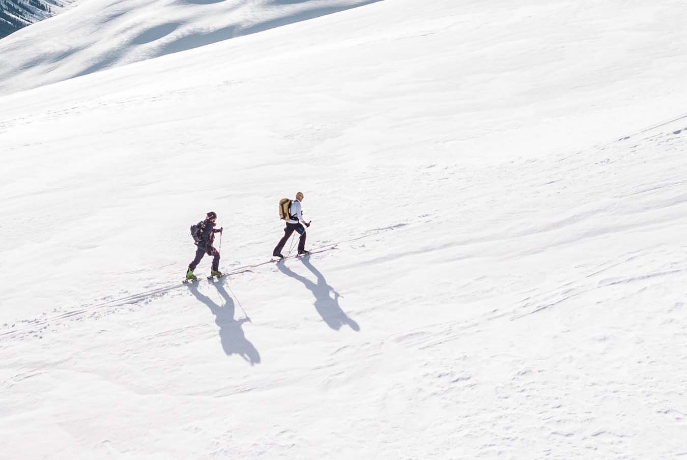 Skiers ski touring up a mountain
